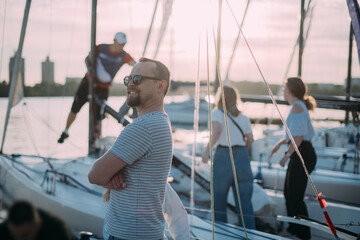 Preparation for the regatta at the yachting school at the marina with sailing yachts.