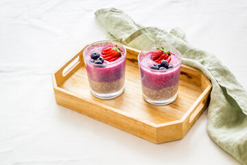 Smoothie and chia seeds pudding with strawberries in glasses