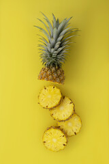 Creative layout made of fresh pineapple isolated on yellow background. From top view