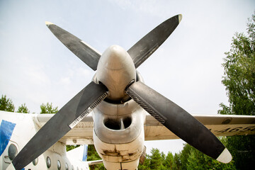 propeller and airplane wing against cloudy sky
