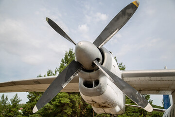 Naklejka na ściany i meble propeller and airplane wing against cloudy sky