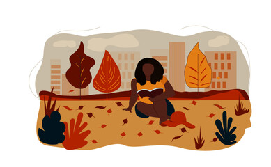 Beautiful woman with afro hairstyle reading a book in the autumn park.