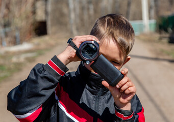 Young guy filming on the street
