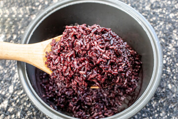 Healthy Riceberry Rice In a wooden spoon.
