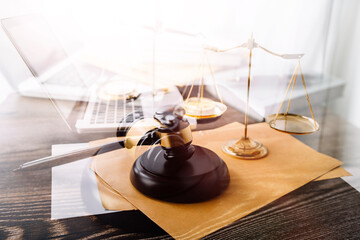 Women lawyer working with contract papers and wooden gavel on tabel in courtroom. justice and law ,attorney, court judge, concept.