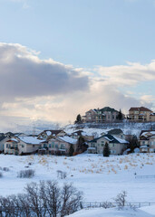 Fototapeta na wymiar Vertical Residential area on top of a snowy mountain with large houses