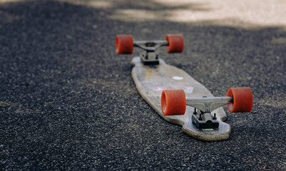 Closeup of a skateboard turned upside down on an asphalt road