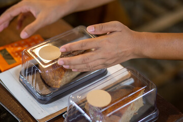 Selective focus brown paper label attached to the front of the cake box Leave space to enter text. vintage cake shop