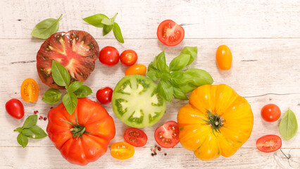 colorful tomatoes and basil- top view