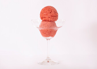 Strawberry ice cream in a glass with ingredients used to decorate the background