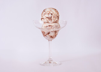 Powdered milk ice cream with chocolate in a glass with ingredients used to decorate the background