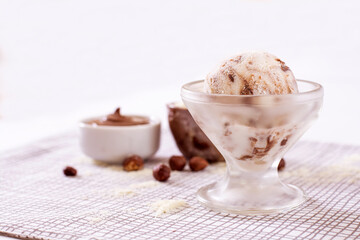 Powdered milk ice cream with chocolate in a glass with ingredients used to decorate the background