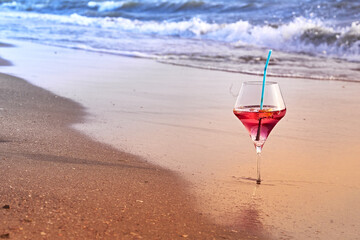 Wine glass with a cocktail by the sea.