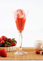 ice cream flavored red fruits in the bowl with ingredients in the decoration
