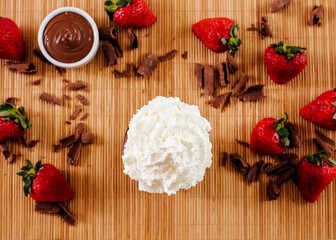 top view dessert with whipped cream with ingredients and strawberries in the decoration