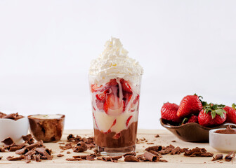 chocolate dessert with strawberry in the glass with ingredients in the decoration