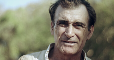 Middle aged farmer on farmland smiling looking at the camera