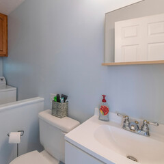 Square frame Small bathroom and laundry combo interior with sink and wooden cabinet