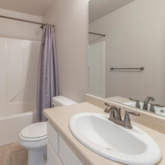 Square frame Bathroom interior with hand railing and bathroom vanity sink with marble countertop