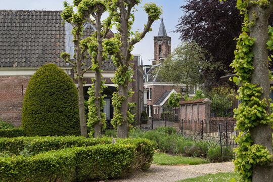 Garden and street overlooking the historic reformed church in the center of Loenen, Netherlands.