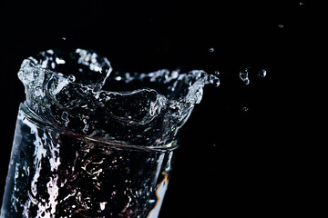 Strawberries fall into a glass of water. Water spills out of a glass.Making drinks. .Mix drinks. Water splashes. A stream of water. Wave. Splashing water.