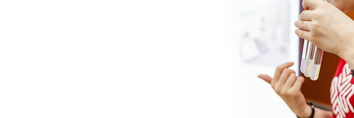 Glass test tubes in his hands and test tubes with blood samples for medical tests in a snow-white laboratory stand. The forensic expert holds a test tube with a dna sample. A paternity test. Banner