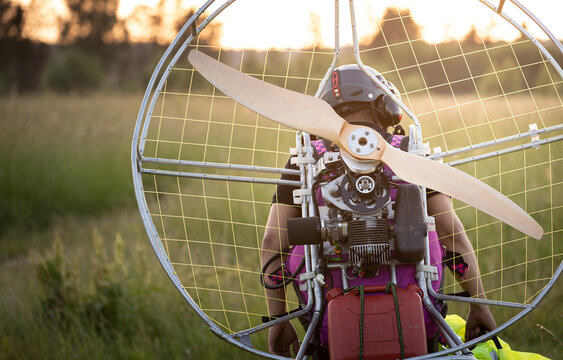 A male pilot is preparing a gasoline-powered paralet for flights. Paragliding for individual paragliding flights. Preparation for wing flight. Extreme sports.