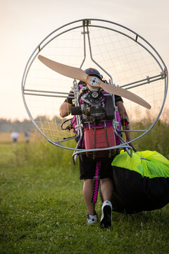 A male pilot is preparing a gasoline-powered paralet for flights. Paragliding for individual paragliding flights. Preparation for wing flight. Extreme sports.