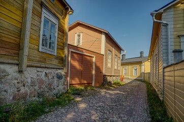 Old middle age style cobblestone town street with old buildings