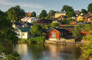 Fototapeta na wymiar Old village with wooden houses In a riverbank