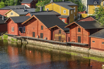 Red orange fisherman warehouses houses in the river canal in the old city of Porvoo Finland. Tourism destination