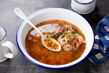 Homemade organic bone Broth soup with Meat and Vegetables in a white bowl, selective focus