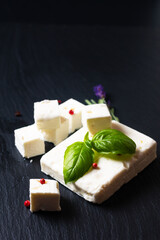 Food concept Organic Feta Cheese on black slate stone board with copy space