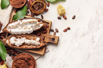 Composition with fresh cocoa fruits, powder and beans on light background