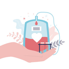 Hand holds plastic container with donor blood. Plasma sample tubes. World blood donor day