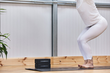 reonocible faceless partial detail of woman practicing yoga poses or pilates in balance