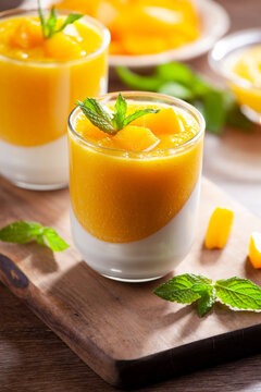 Glass of homemade panna cotta with mango sauce