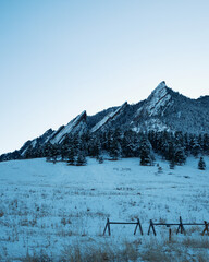 boulder flatirons landscape covered in snow during a sunny winter day