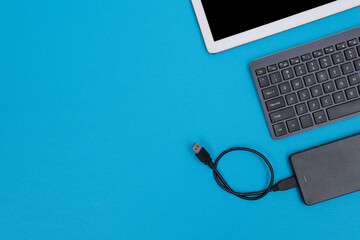 Office Workplace with Digital Gadgets Lying on Blue Table - Flat Lay