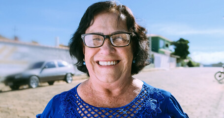 Smiling old Latin woman. Beautiful senior woman looking at the camera with a warm friendly smile...