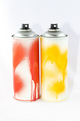 Two Colored Spray Paint Cans on White Background. Graffiti's Inventory - Close-Up Shot