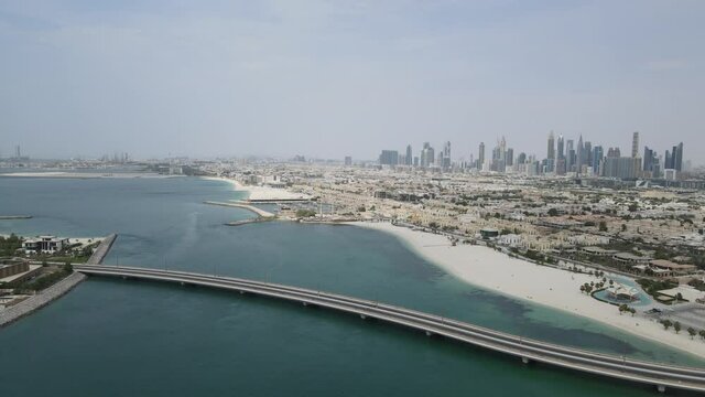 Aerial view of and bridge over water in Dubai and cars passing