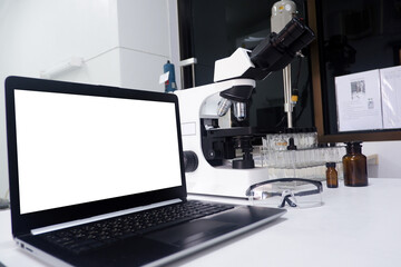 Cropped shot view of white office desk table with the office equipments, alcohol sanitizer, face mask and other office supplies on the modern space, flat lay.work at home.