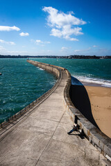 Vertical shot of people on a pier enjoying the sunny d