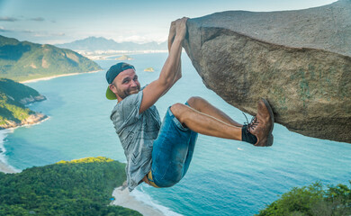 man hangs on a rock with no insurance. © Aliaksei