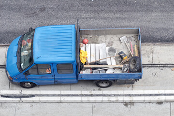 Pickup truck carrying construction equipment on a street reconstruction.