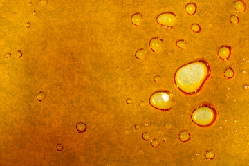 texture golden cannabis wax, marijuana dab macro background