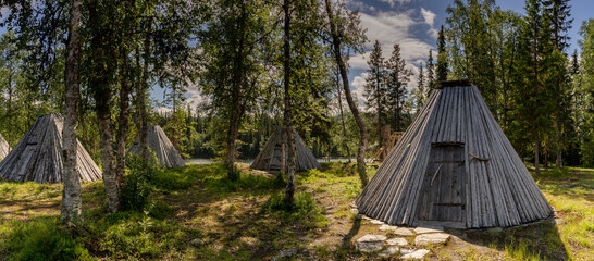 view of many historic Sami Lavvu huts or wooden tipis in Ankerede in northern Sweden