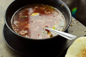 Ukrainian borscht red soup with sour cream close-up in a bowl on the table. Horizontal