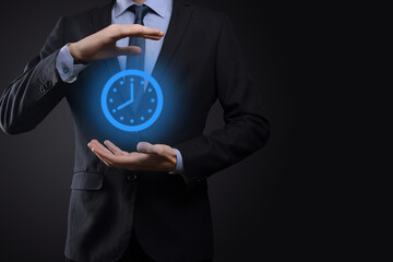 Businessman hand holds the icon of hours clock with arrow. Rapid execution of the work.Business time management and business time is money concepts